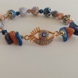 Dyed blue mother of pearl, sunstone, lapis evil eye with lashes bracelet